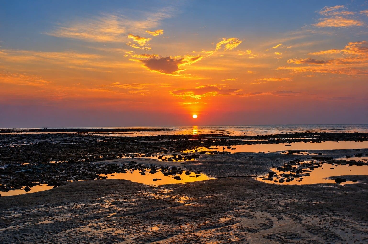 ভাটার সময় প্রবালের চরের ওপর অস্ত যাচ্ছে সূর্য